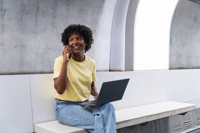 A healthcare interpreter on a remote video call, phone and laptop in hand